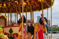 People enjoy themselves on a carousel at the Liverpool Docks, Port of Liverpool, late on a cloudy afternoon