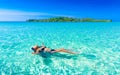 People enjoy vacation on tropical sandy beach on background sea water and blue sky Royalty Free Stock Photo