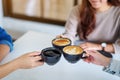 People enjoyed drinking and clinking coffee cups together on the table in cafe Royalty Free Stock Photo