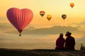 People enjoyed sunrise at the mountain top with scenic view and hot air balloon Royalty Free Stock Photo