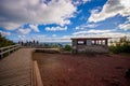 People enjoying the beautiful view from top in the mountain in Rangitoto Island wlaking in wooden paths, New Zealand in