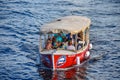 People enjoying colorful bay boat on Hillsborough river in downtown area.