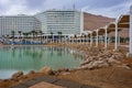 People enjoying the Dead Sea at golden hour Royalty Free Stock Photo