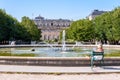 People enjoying the fountain in the Palais-Royal garden in Paris, France Royalty Free Stock Photo