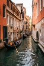 People enjoying gondola ride in a canal in venice Royalty Free Stock Photo