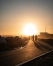 People enjoying a leisurely bike ride at the golden hour light of a beautiful sunset Royalty Free Stock Photo