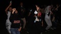 People enjoying music dancing and joking together at night
