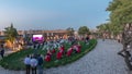 People are enjoying the open air cinema in the hictoric building at evening timelapse Royalty Free Stock Photo