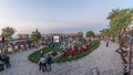 People are enjoying the open air cinema in the hictoric building at evening timelapse Royalty Free Stock Photo