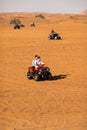 People enjoying quadbike or ATV in Dubai Desert