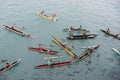 People enjoying rain in canoes on Pacific Ocean Royalty Free Stock Photo
