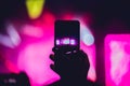 People enjoying rock concert and taking photos with cell phone a Royalty Free Stock Photo