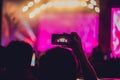 People enjoying rock concert and taking photos with cell phone at music festival Royalty Free Stock Photo