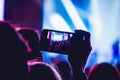 People enjoying rock concert and taking photos with cell phone a Royalty Free Stock Photo