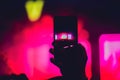 People enjoying rock concert and taking photos with cell phone a Royalty Free Stock Photo