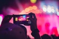 People enjoying rock concert and taking photos with cell phone a Royalty Free Stock Photo