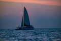 People enjoying of sailboat and parasail on colorful sunset background in Gulf Coast Beaches 2