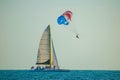 People enjoying of sailboat and parasail on colorful sunset background in Gulf Coast Beaches 3