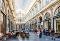 People enjoying the shops and sidewalk cafes in the Saint-Hubert Royal Galleries in Brussels, Belgium Royalty Free Stock Photo