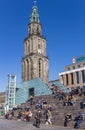 People enjoying the spring sun in front of the Martini tower