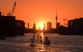 People enjoying summer in Berlin on river with sunset sky, Oberbaum Bridge, Tv Tower