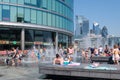 People enjoying summer at a fountain in London