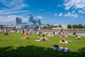 People enjoying summer near Tower Bridge in London with a view of the city skyline Royalty Free Stock Photo