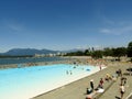 People enjoying the summer, sunbathing, swimming at the Kitsilano outdoor pool - Vancouver, British Columbia, Canada.