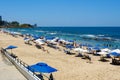 People enjoying sun, beach and blue water at Porto da Barra Beach, Salvadore, Brazil