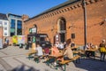 People enjoying the sun at a picknick table during the streetfood festival in Aarhus