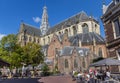 People enjoying the sun at the St. Bavo church in the center of