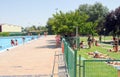 People enjoying a sunny day next to the municipal swimming pool in Zamora, Spain.