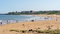 People enjoying the sunny weather on Longsands beach at the coast in Tynemouth, North Tyneside. UK