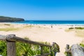 People enjoying the sunny weather at Pebbly Beach, a popular camping area with great surfing beach and bush walks within Royalty Free Stock Photo