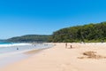 People enjoying the sunny weather at Pebbly Beach, a popular camping area with great surfing beach and bush walks within Royalty Free Stock Photo