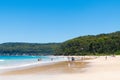 People enjoying the sunny weather at Pebbly Beach, a popular camping area with great surfing beach and bush walks within Royalty Free Stock Photo