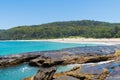 People enjoying the sunny weather at Pebbly Beach, a popular camping area with great surfing beach and bush walks within Royalty Free Stock Photo