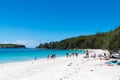 People enjoying the sunny weather at the tranquil, white-sand Murrays Beach in Jervis Bay, Booderee National Park, NSW, Australia