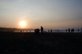People are enjoying the sunrise on the beach of Sayang Heulang Indonesia Royalty Free Stock Photo