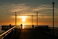 People enjoying sunrise at the pier in New Brighton Royalty Free Stock Photo
