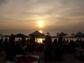 People enjoying sunset dinner at the beach