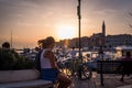 People enjoying the sunset in front of the old town of Rovinj in Croatia