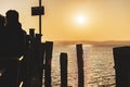 People enjoying sunset at Garda lake pier Royalty Free Stock Photo