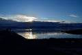 People enjoying the sunset over snowy mountain and calm fjord Royalty Free Stock Photo