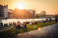 People enjoying sunset at river next to the Berlin Wall / East Side Gallery in Berlin, Germany