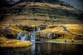 People enjoying their trip in a picturesque waterfall and river, surrounded by lush green foliage