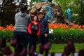 People enjoying tulips on display in Washington Park Albany NY on a rainy afternoon in spring