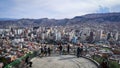 people enjoying the view of a large city from a lookout point