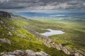 People enjoying a walk on steep stairs of wooden boardwalk on the bank of the Cuilcagh Mountain Royalty Free Stock Photo