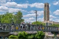 People enjoying a warm sunny day along Lachine Canal with Atwater tower in the background